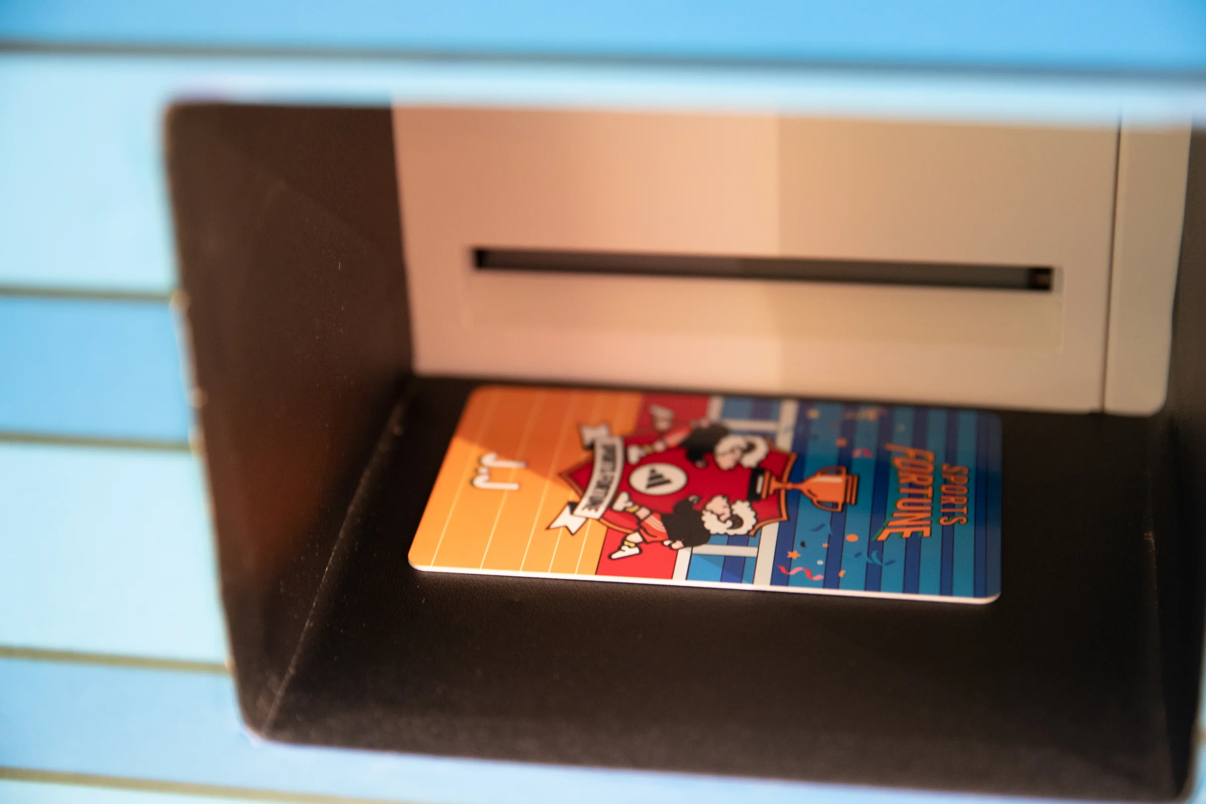 A freshly printed fortune card in the slot