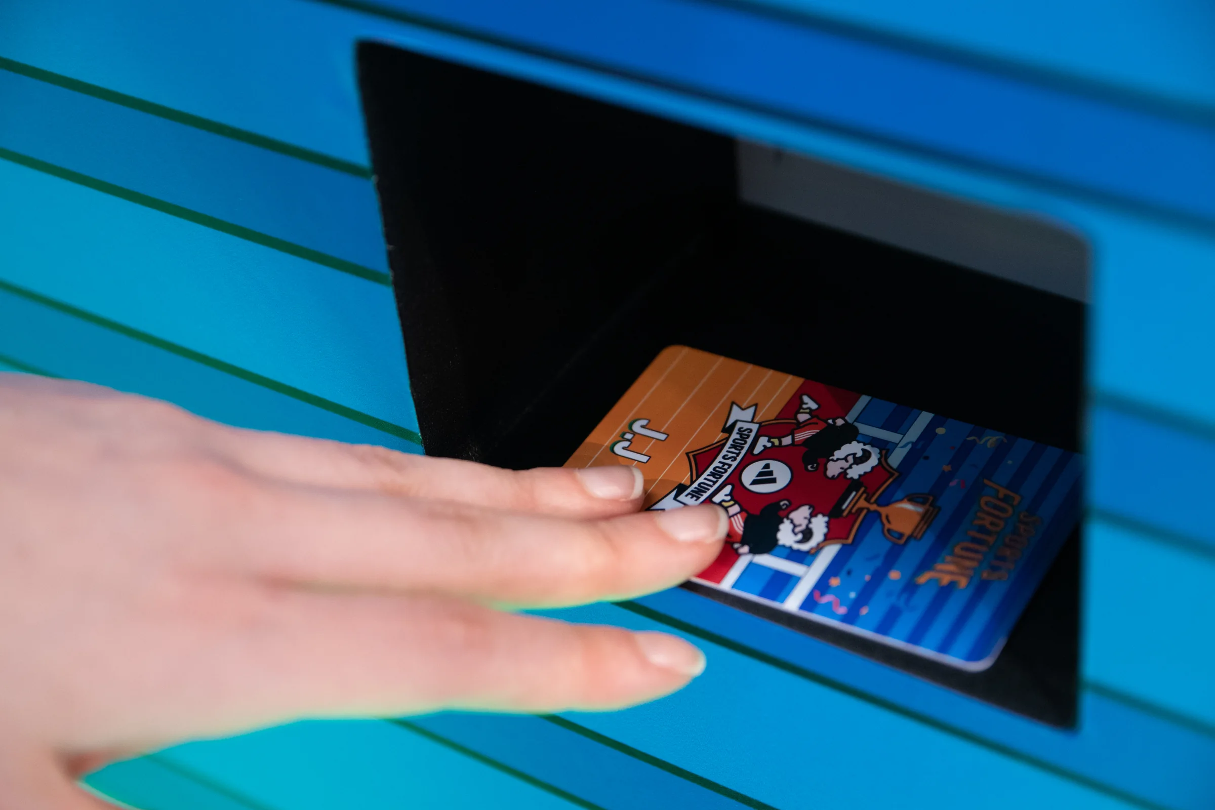A hand picks up the fortune card from the slot.