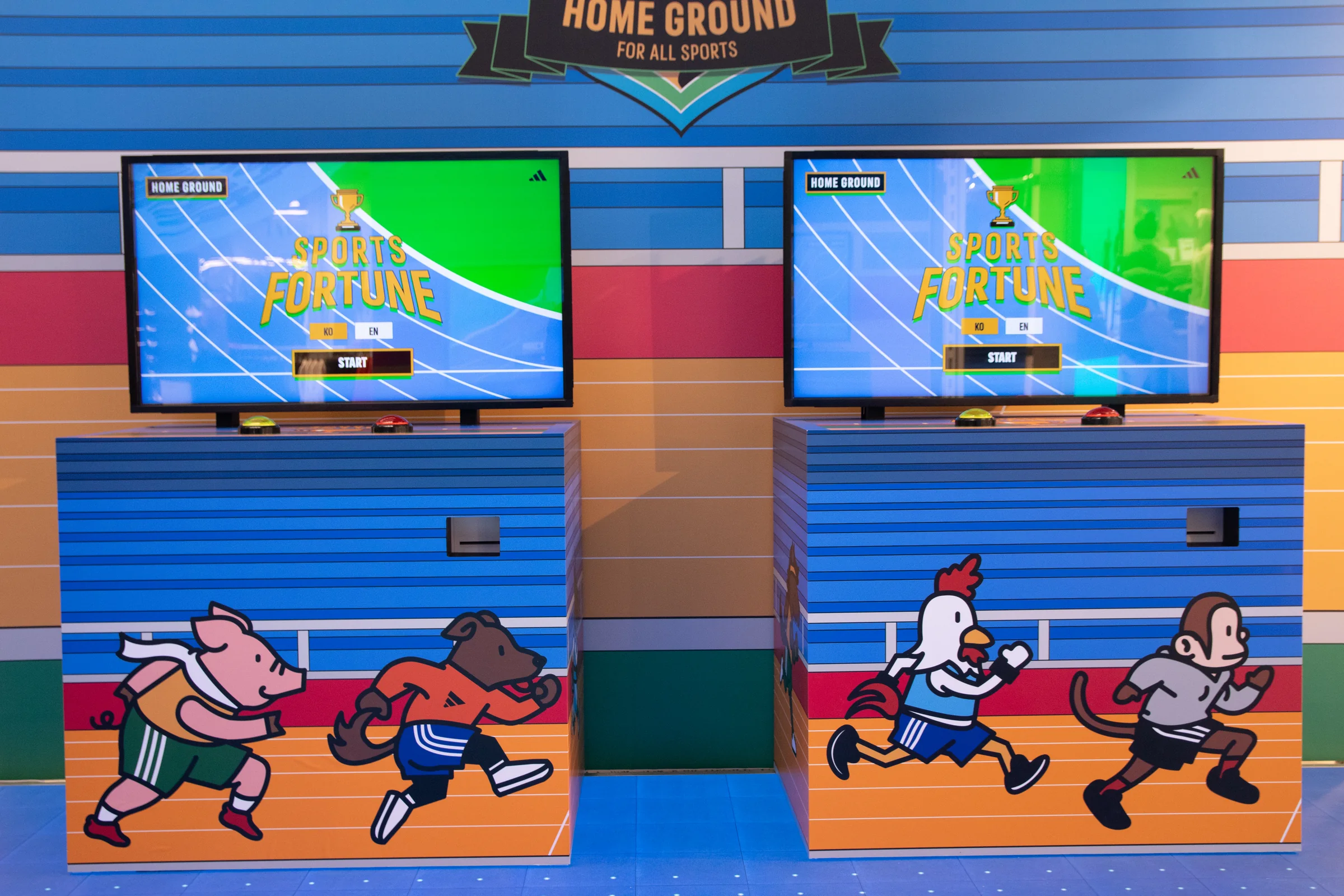Two machines under the HOME GROUND badge, with start screens above and zodiac characters on their fronts
