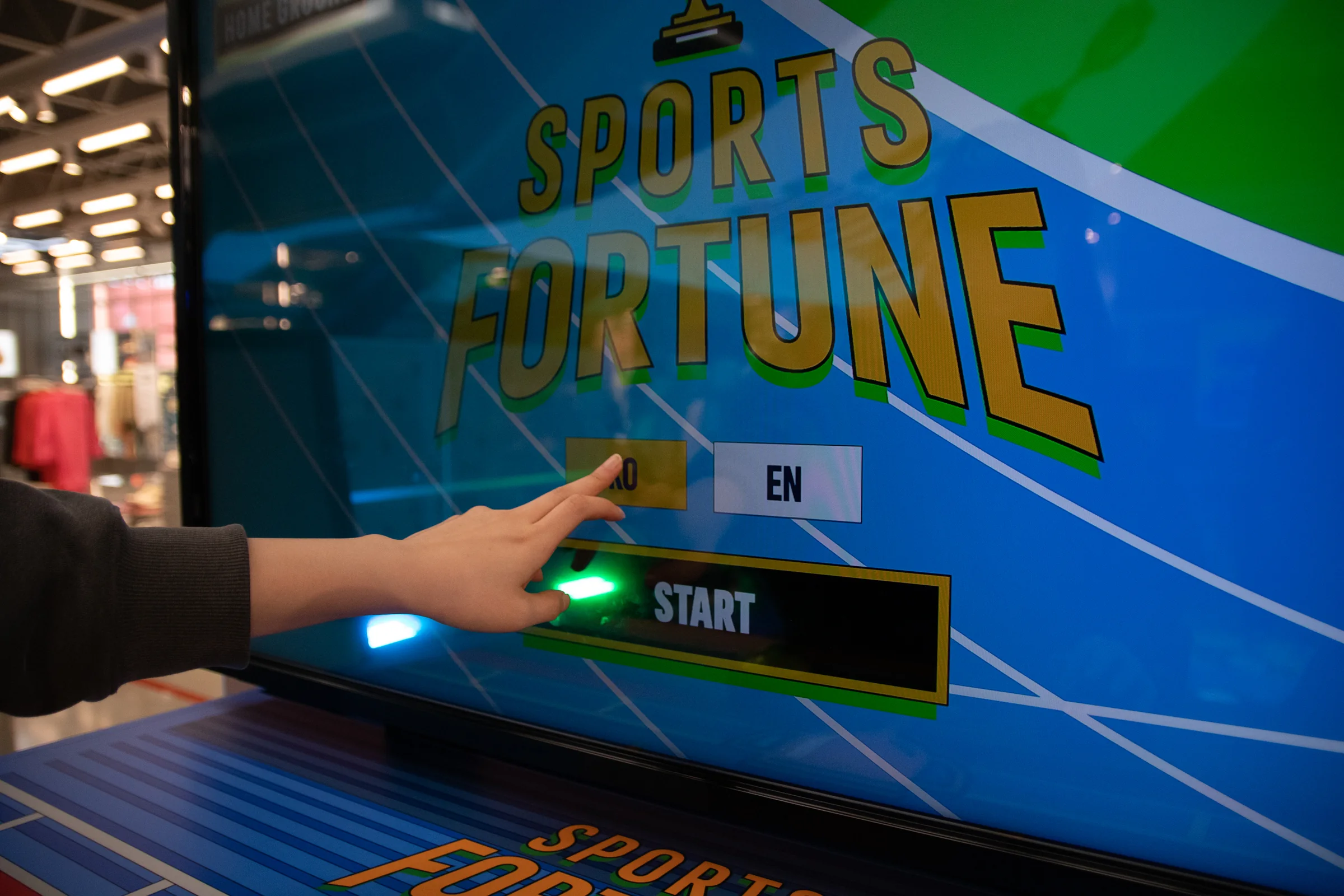 A hand presses KO on the start screen.