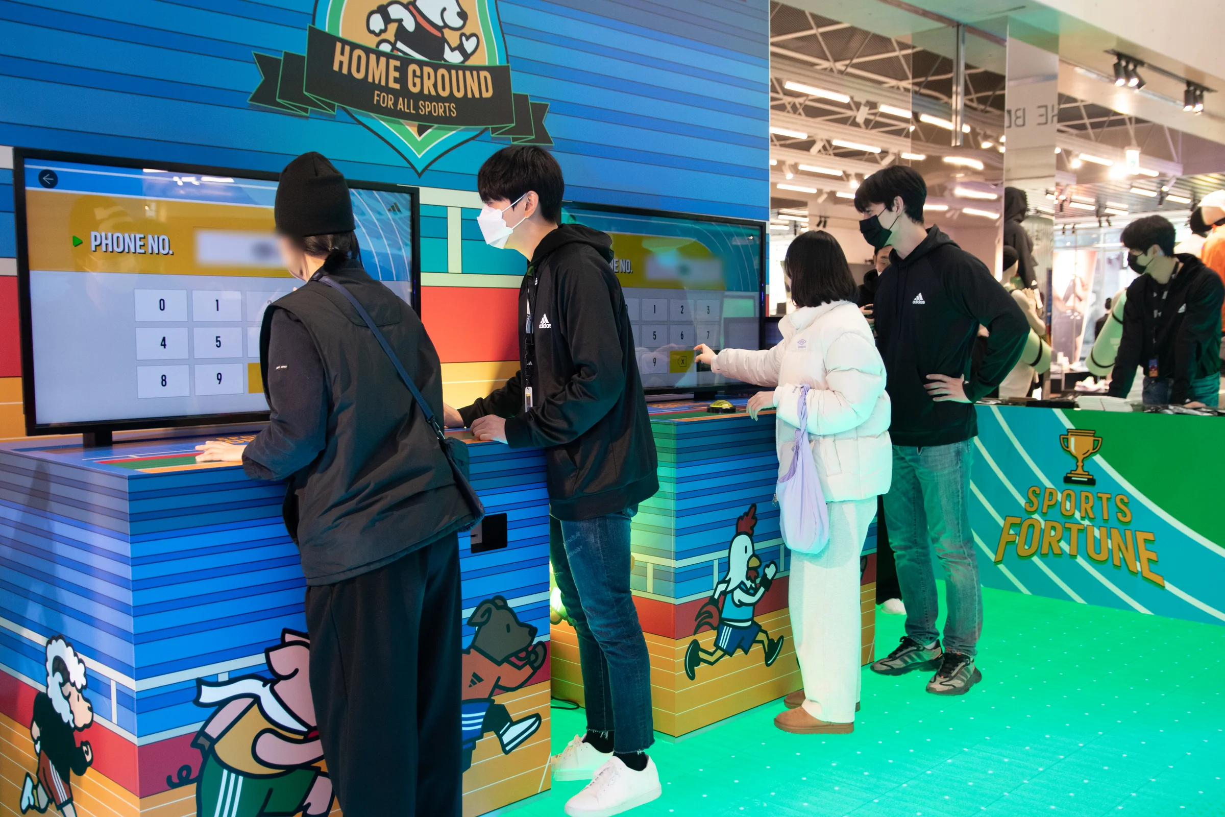 Participants enter phone numbers while visitors wait behind them.