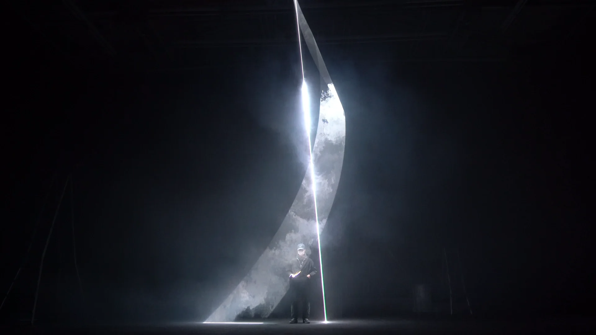スモークの中でレーザーが広い面と直線を描く、KNOVCOMPILEのレーザー作品「Helix」