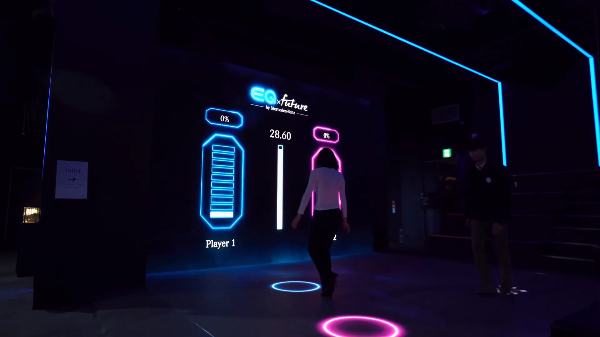 Two battery gauges on the front LED wall and two players on floor circles