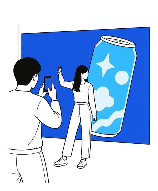넓은 LED 벽의 거대한 3D 캔 앞에서 포즈를 취하는 사람과 휴대폰으로 찍는 친구