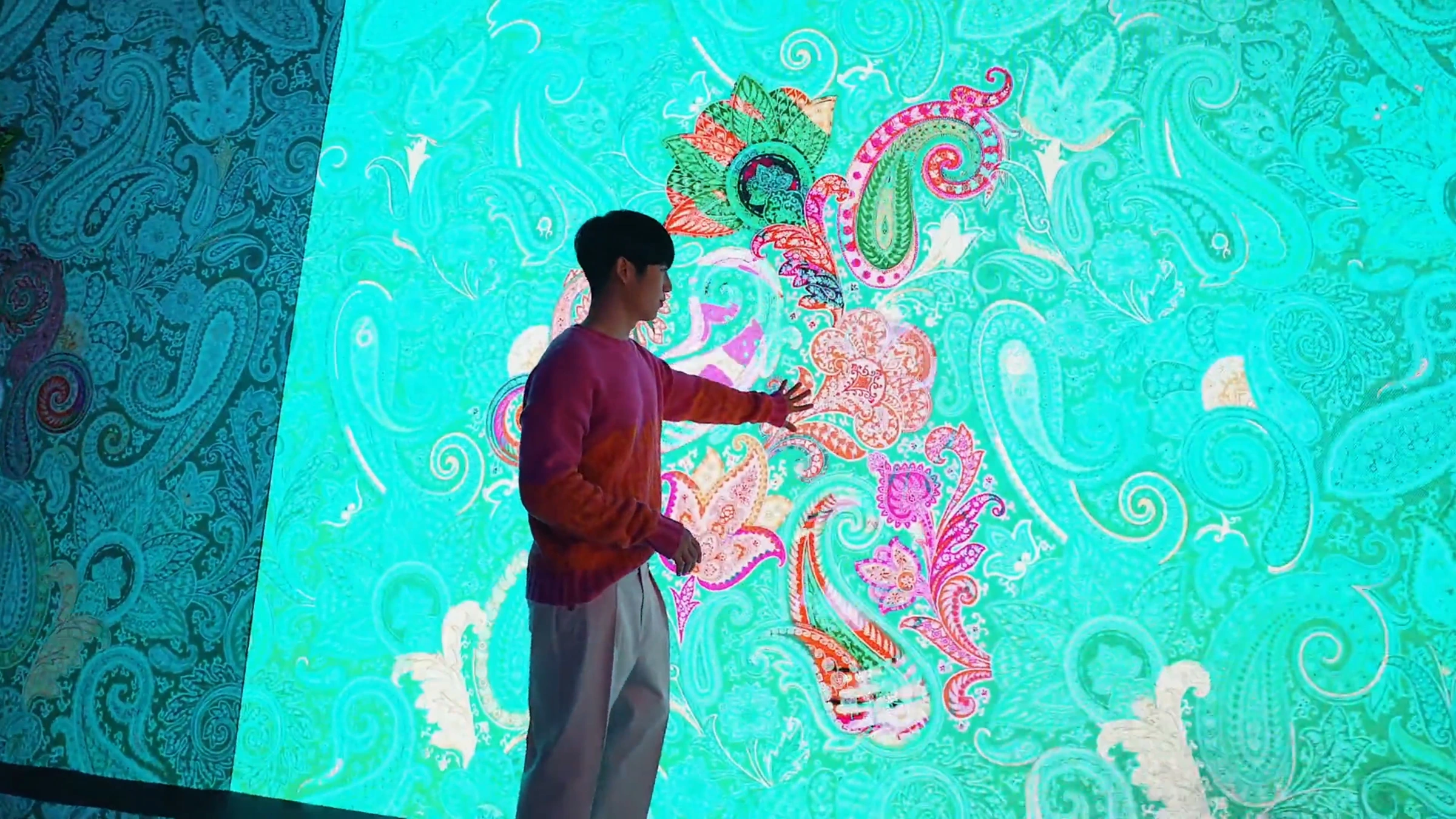A visitor touching the paisley LED wall