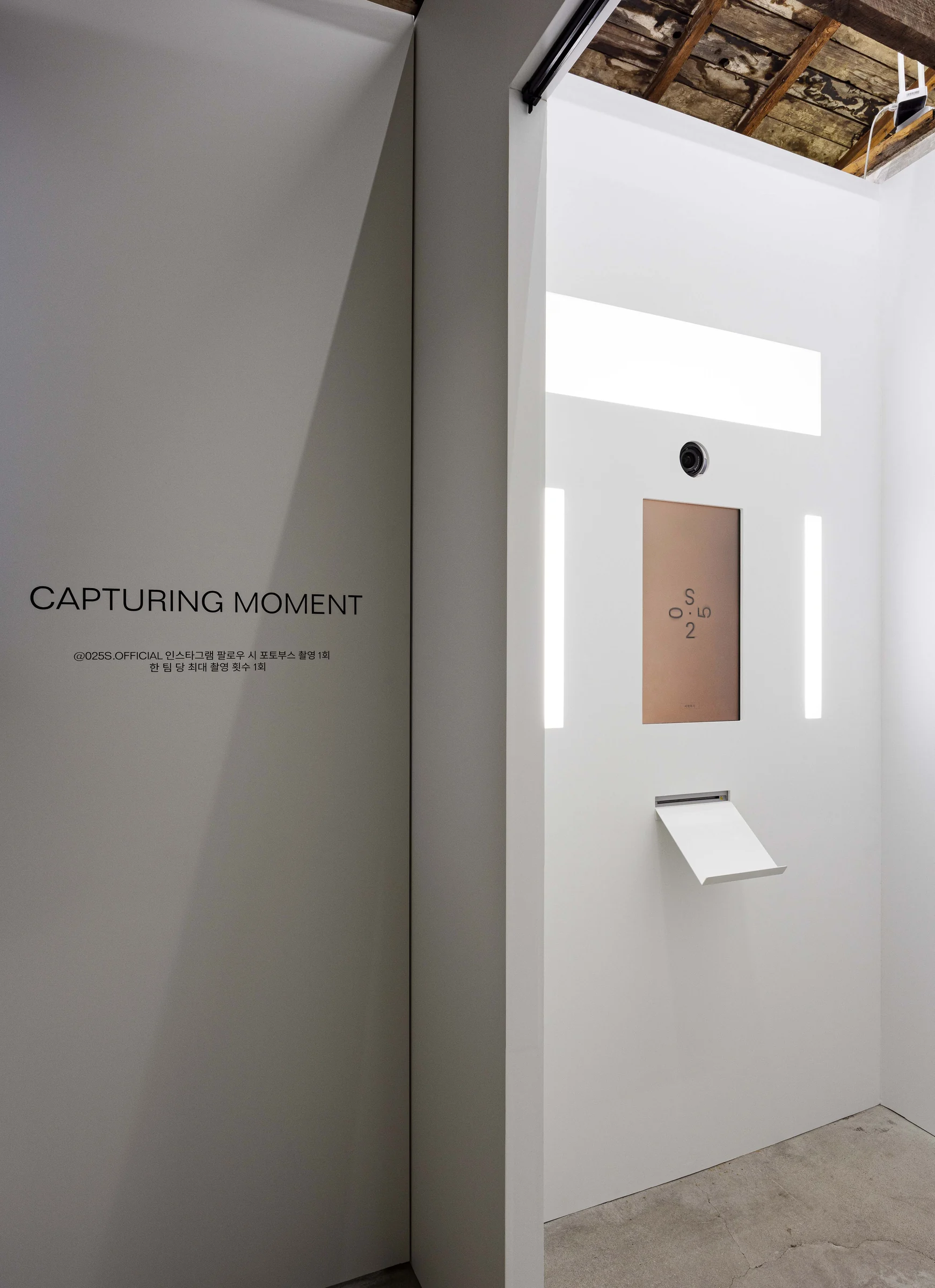 Front panel inside the white booth with the words CAPTURING MOMENT