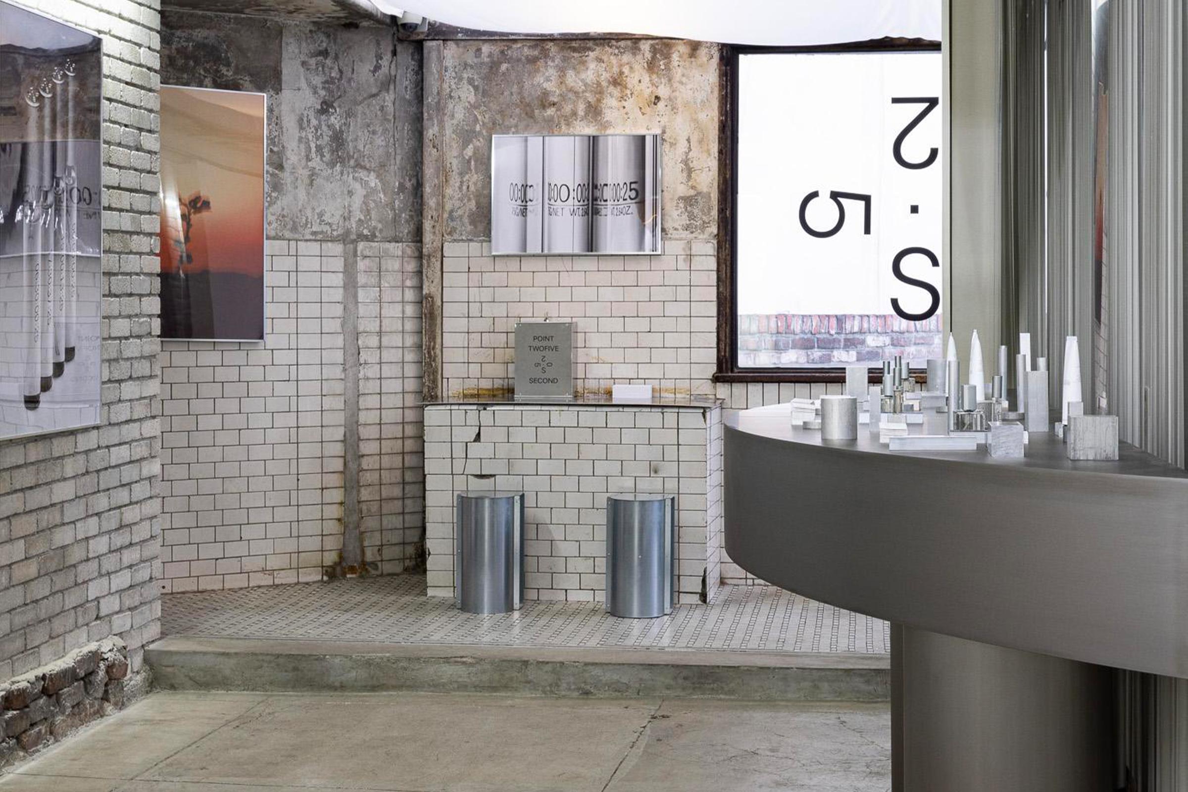 Brand space with a 025S window logo, metal counter and wall posters