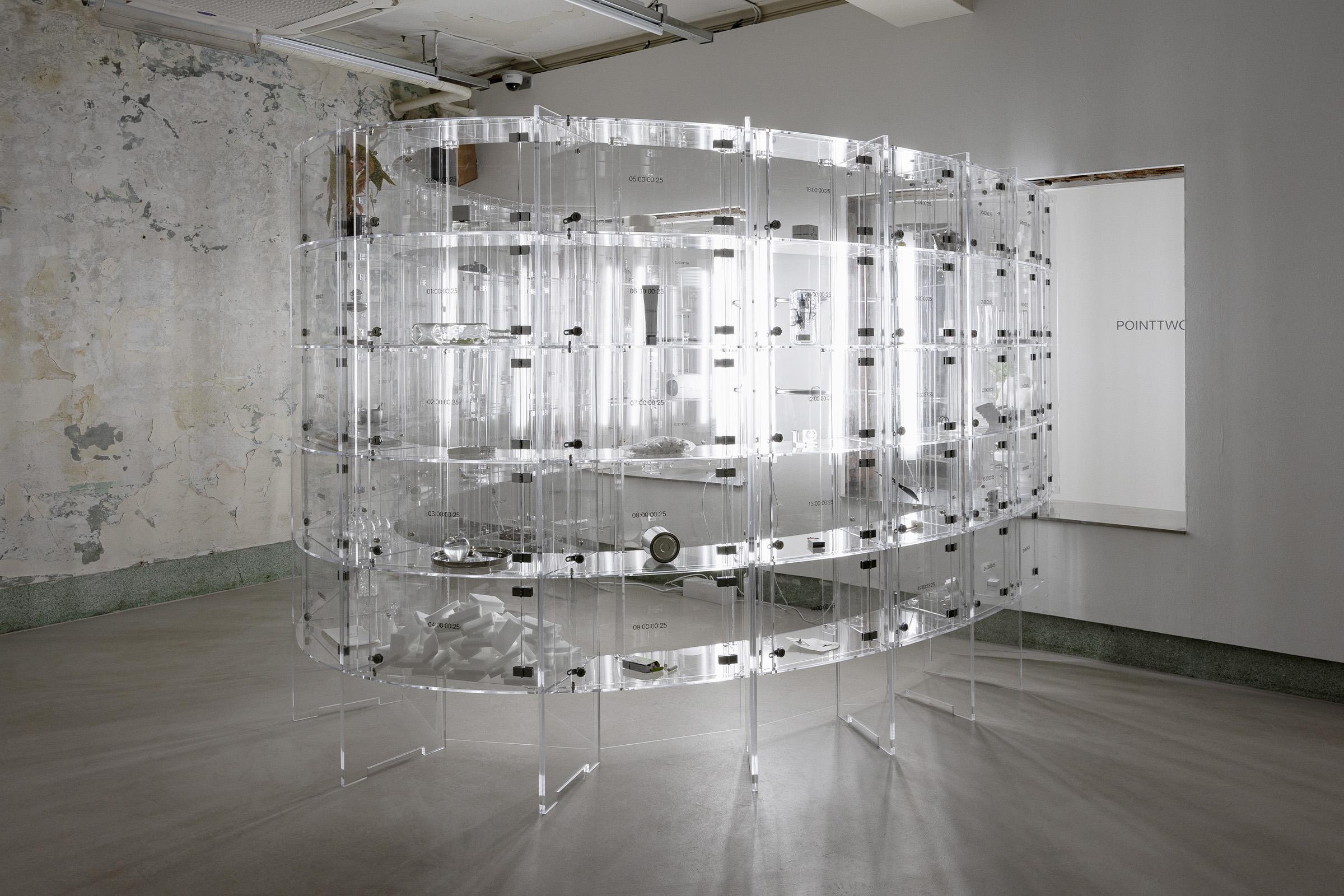 025S exhibition space with clear drawers arranged in a circle