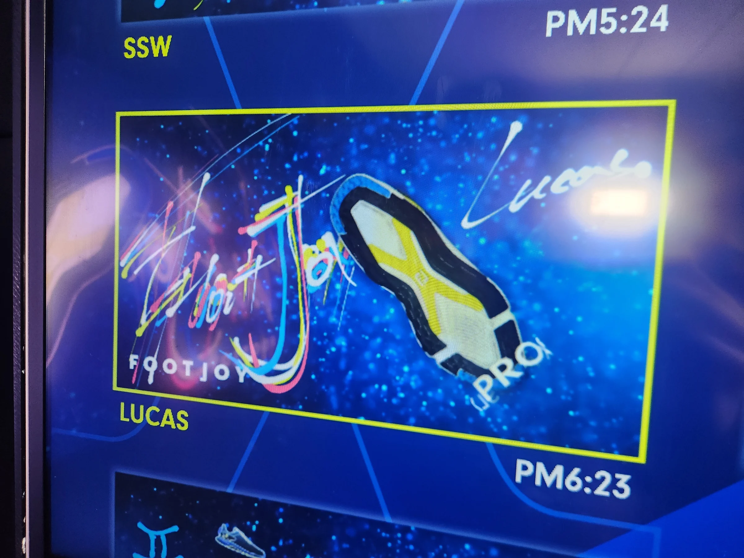 参加者の名前と時刻を添えた靴のデザインが続くLED画面