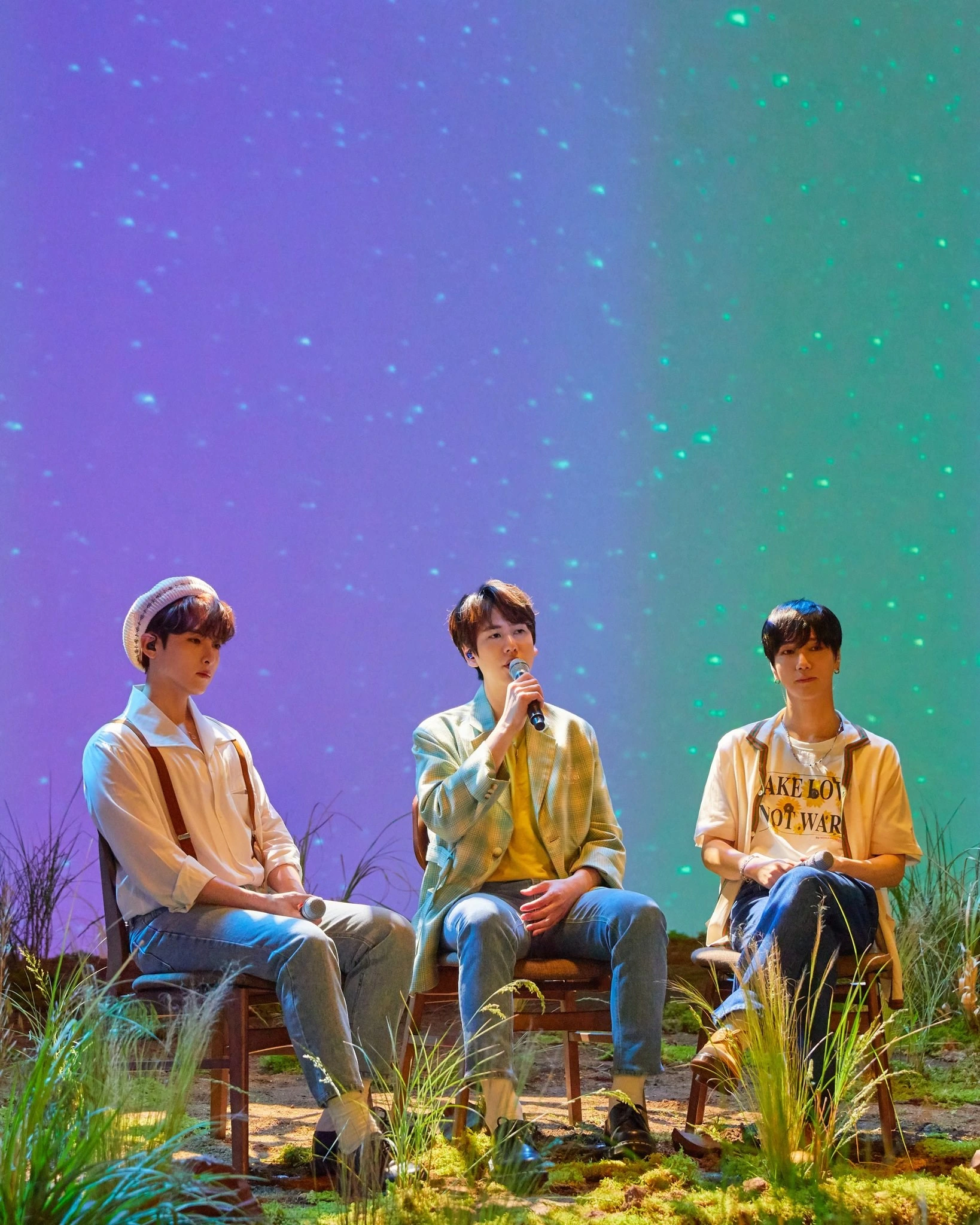 The three members framed by starlight