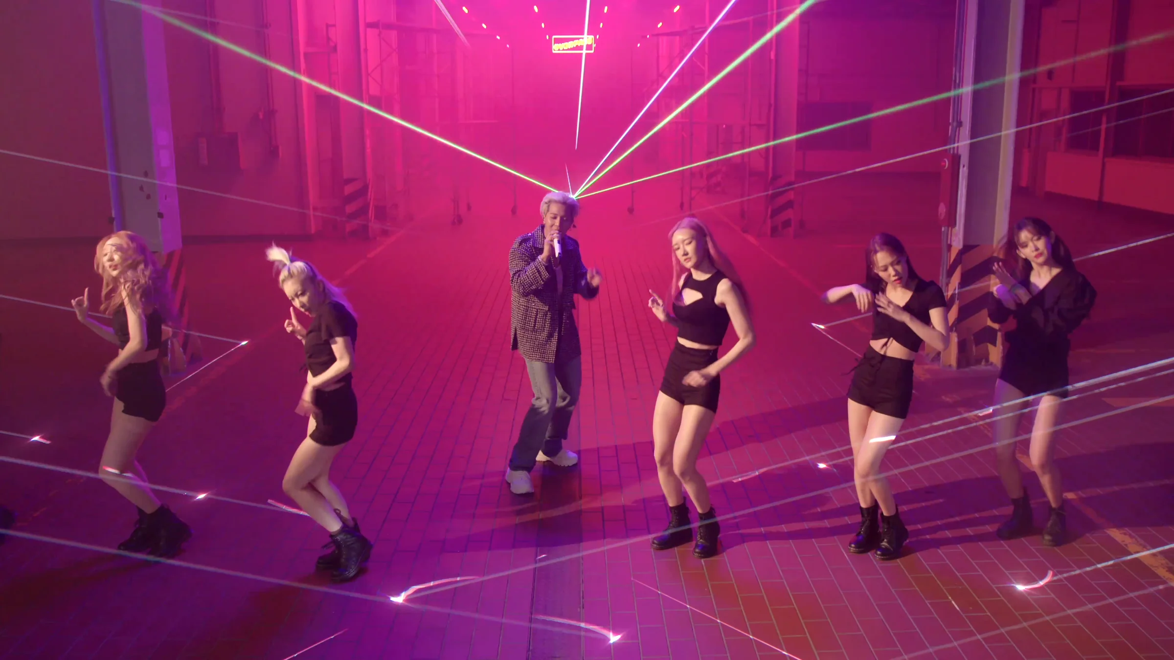 MINO and dancers in a warehouse filled with pink beams