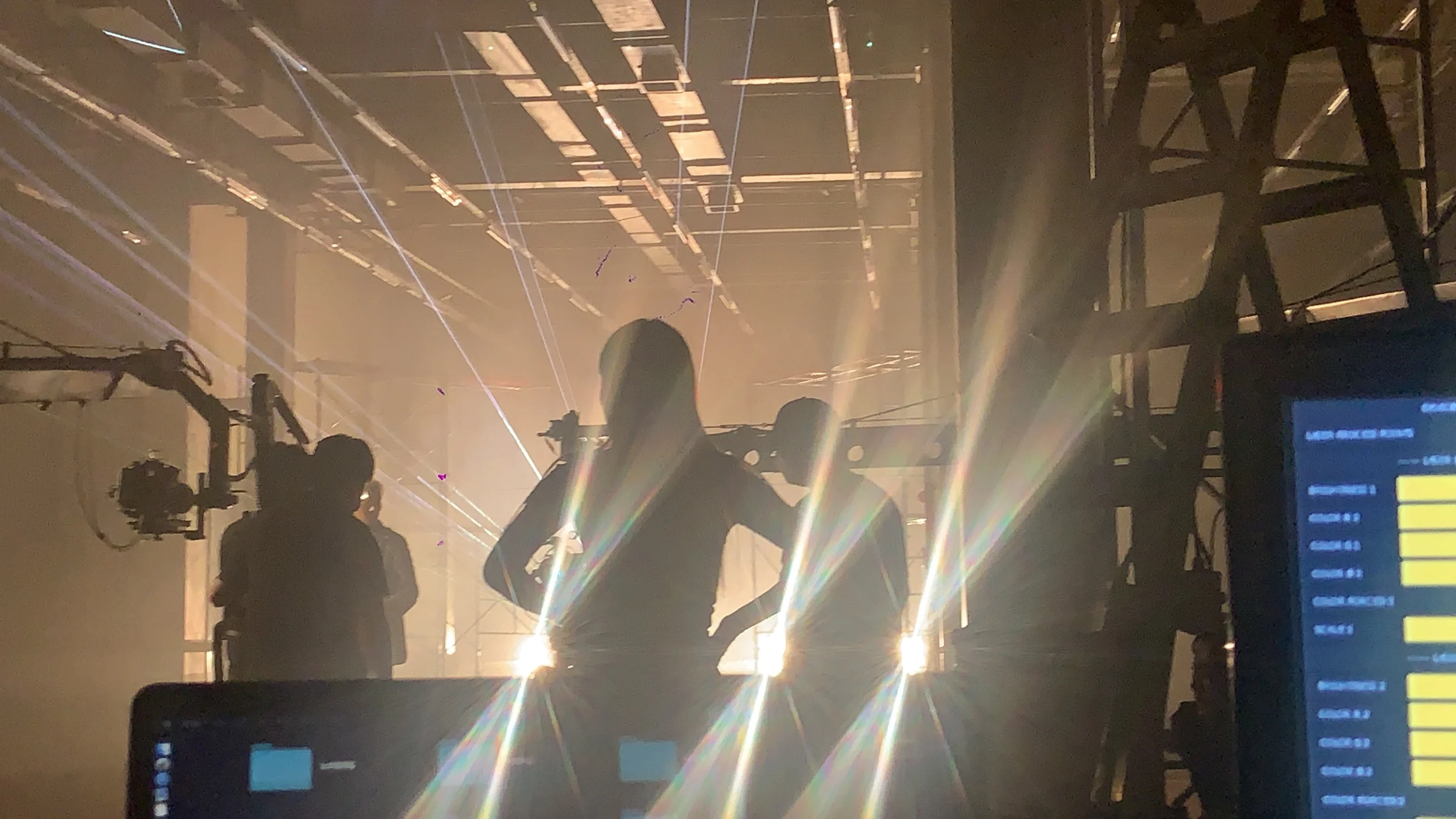 Laser beams and filming equipment in haze, with the laser control interface on the right
