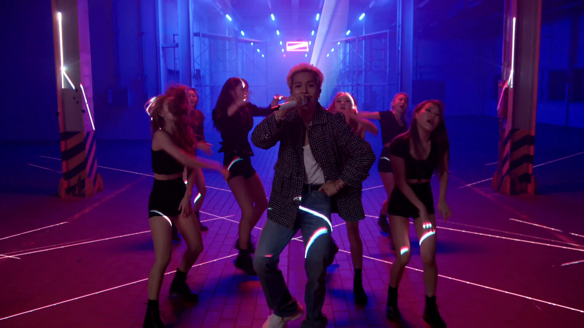 MINO and dancers performing group choreography under blue beams