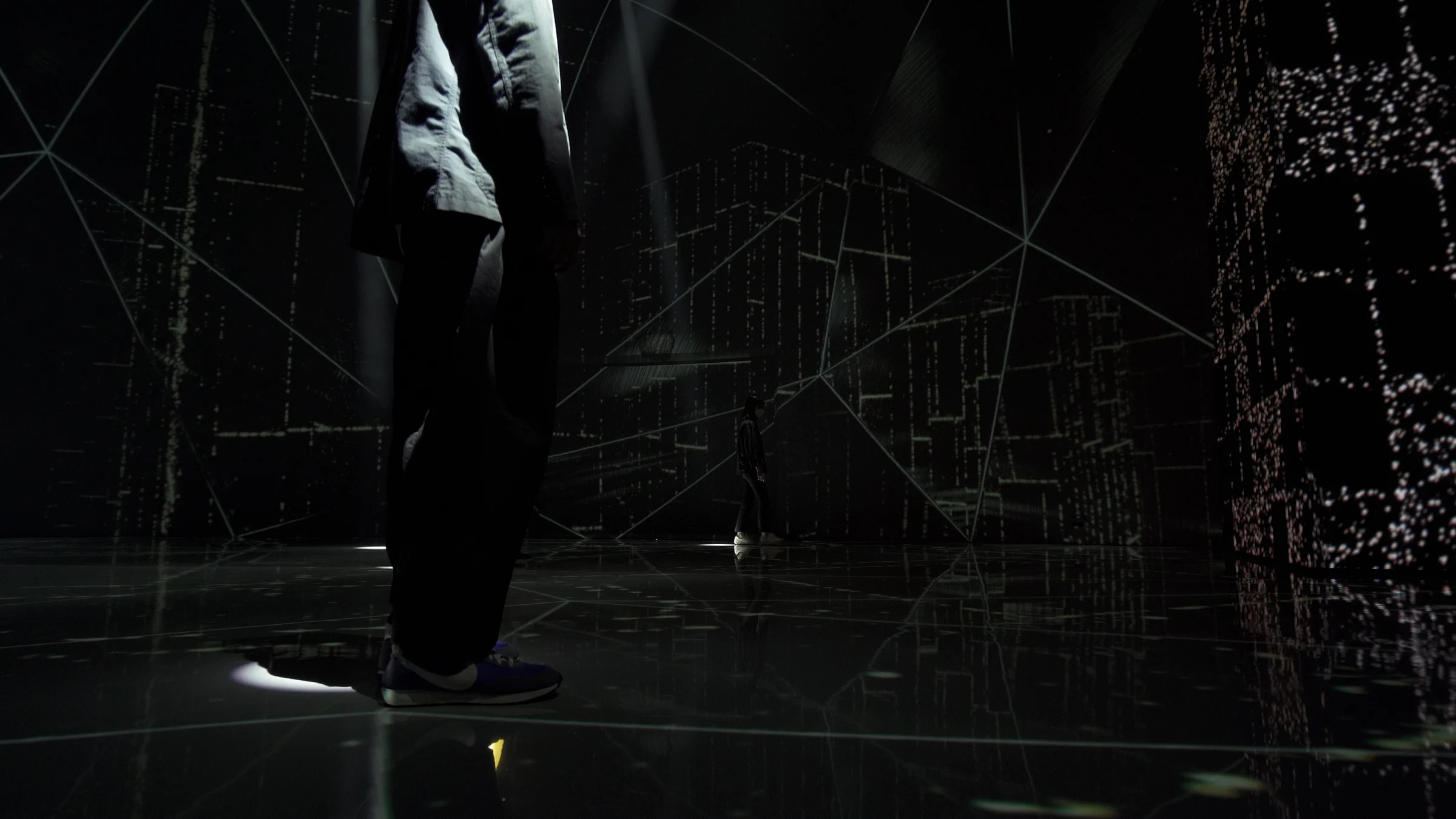 Close-up of a walking visitor's legs and a white circle of light beneath
