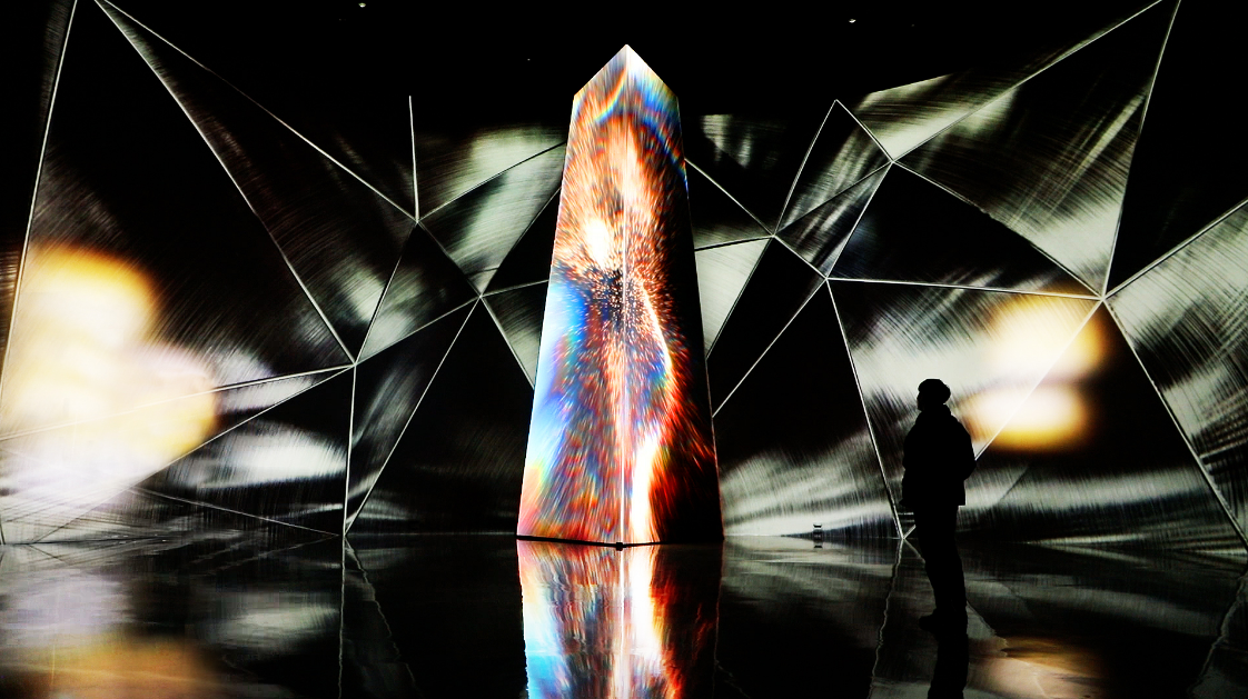 The Civilization of Iron gallery surrounded by silver surfaces and orange-blue LED towers