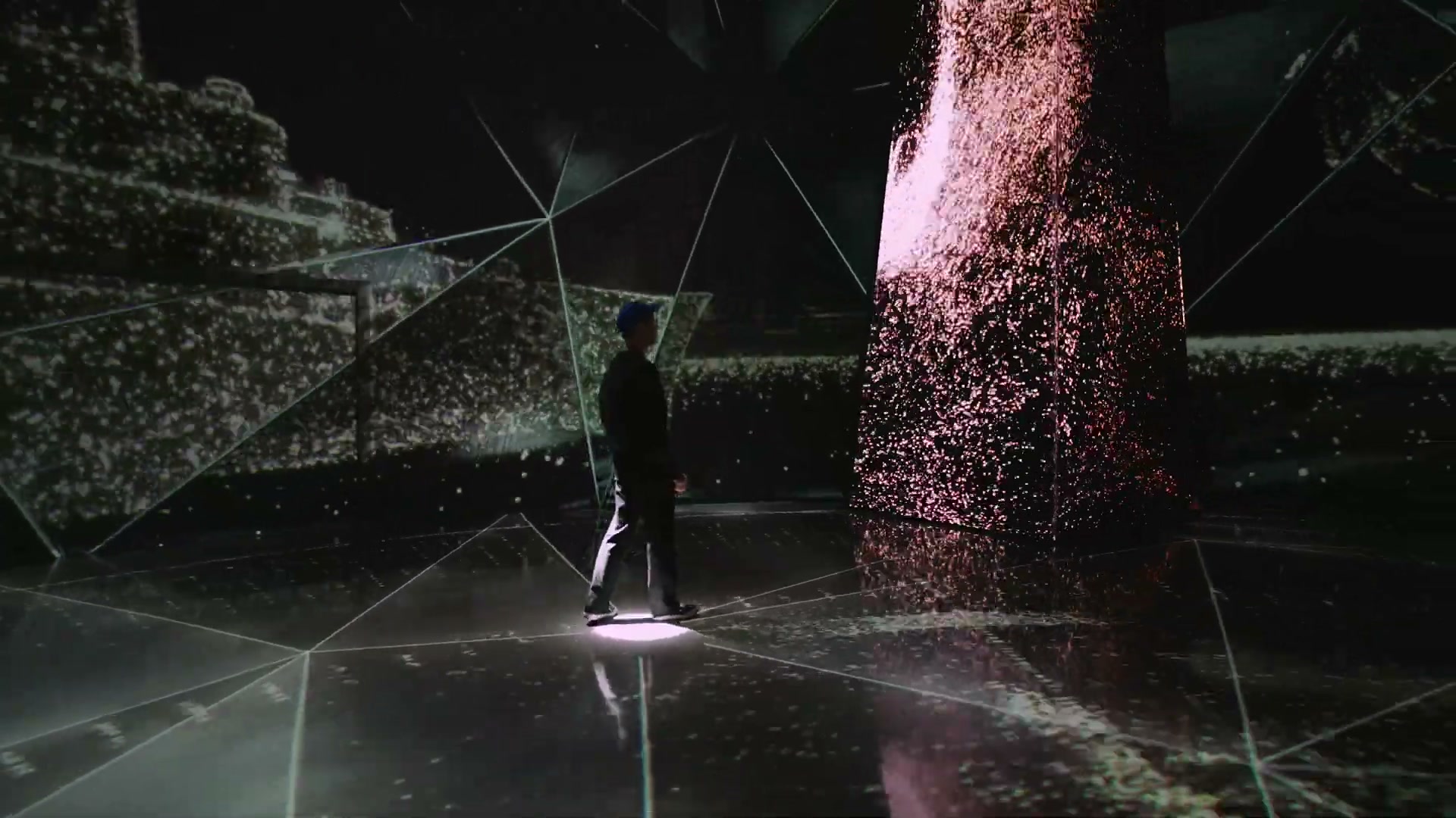 Visitors walking through wireframe imagery with oval lights at their feet