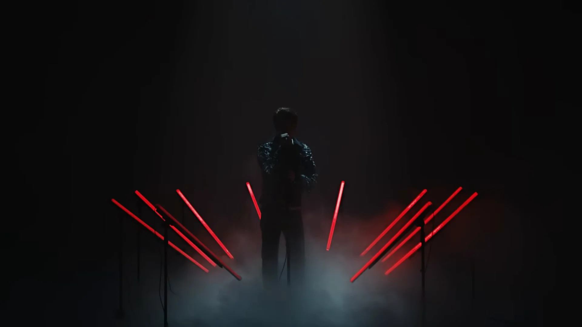 Red bars glow low above the floor haze